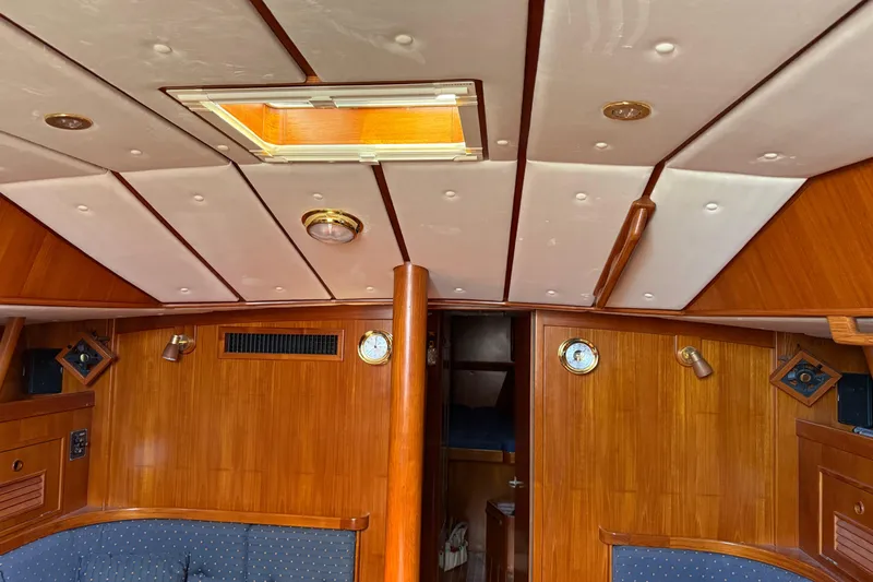 Slide: The Image of Interior of a 1996 Contest 46/48 yacht with wooden paneling and ceiling hatch. - 18
