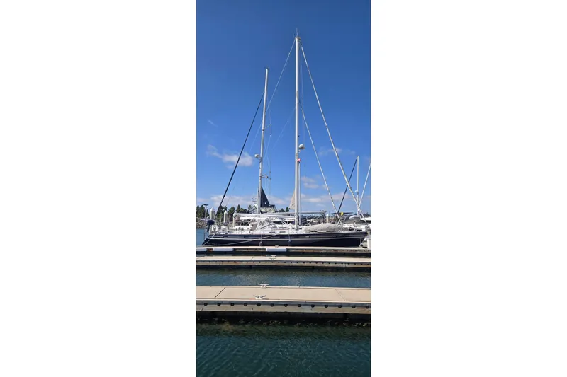 Slide: The Image of Sailboat docked at marina, Contest 46/48 model, 1996, under clear blue sky. - 2