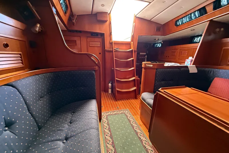 Slide: The Image of Interior of a 1996 Contest 46/48 yacht with wooden furnishings and cozy seating. - 22