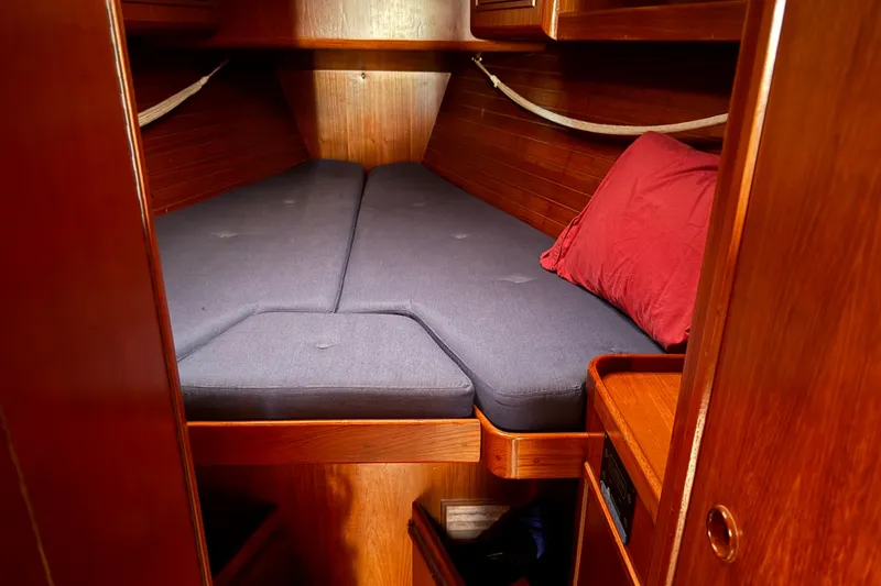 Slide: The Image of Cozy cabin interior of 1996 Contest 46/48 yacht with wooden finish and blue bedding. - 24