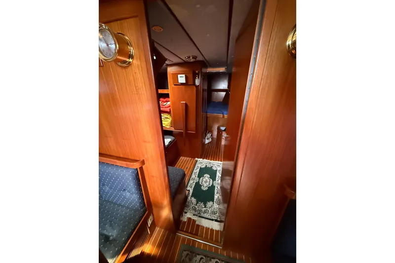 Slide: The Image of Luxurious wooden interior of a 1996 Contest 46/48 yacht cabin with cozy seating and decor. - 26
