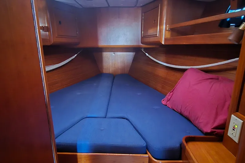 Slide: The Image of Cozy cabin interior of a 1996 Contest 46/48 yacht with blue cushions and wooden finish. - 9