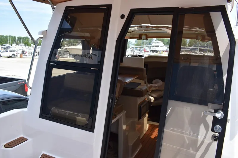 Slide: The Image of 2024 Ranger Tugs R-25 boat interior view with open cabin doors. - 10