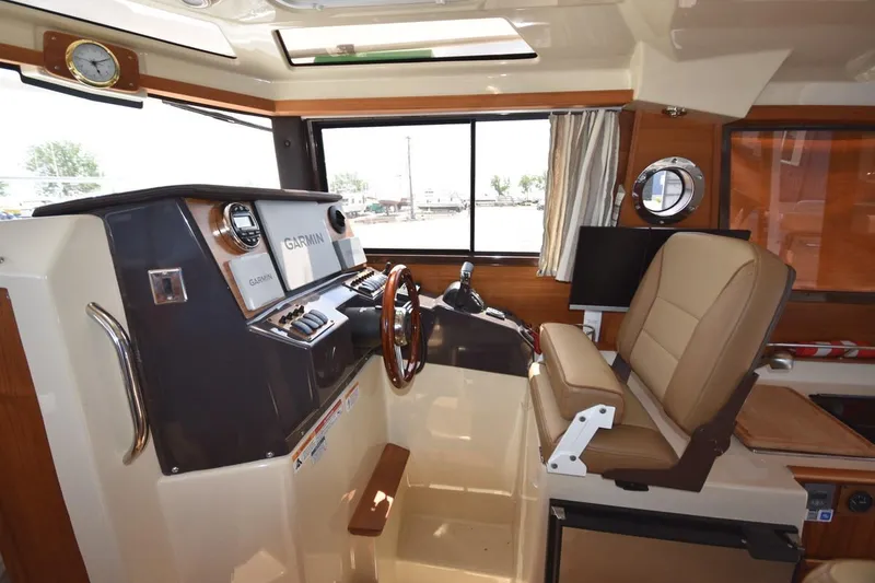 Slide: The Image of Interior of 2024 Ranger Tugs R-25 boat with helm and navigation equipment. - 23
