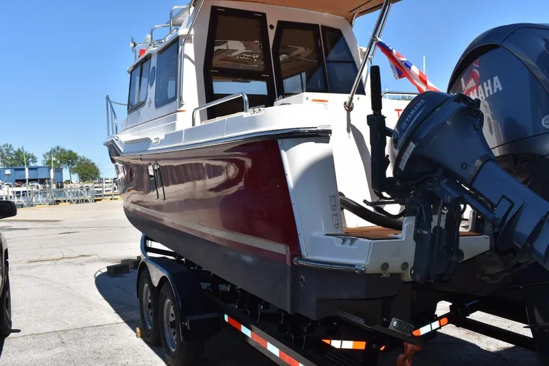 Slide: The Image of 2024 Ranger Tugs R-25 boat on trailer with Yamaha outboard motor. - 25
