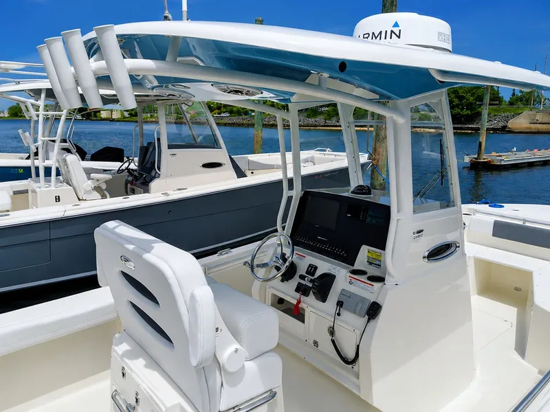 Slide: The Image of 2020 Cobia 240 Center Console boat at dock. - 2