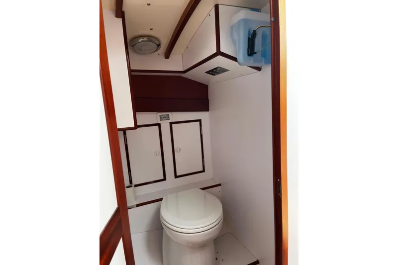 Slide: The Image of 2001 Lyman-Morse Monhegan 30 yacht bathroom with wooden accents and compact design. - 11