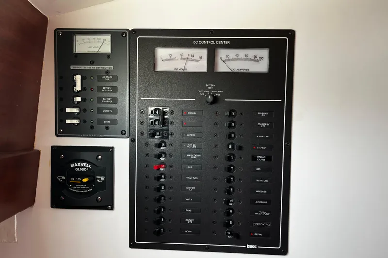 Slide: The Image of Electrical control panel on a 2001 Lyman-Morse Monhegan 30 boat, featuring various switches and gauges. - 13