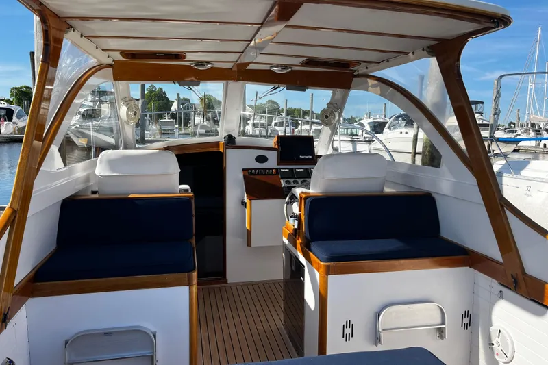 Slide: The Image of Interior of a 2003 Lyman-Morse Monhegan 30 boat, featuring elegant seating and wood accents. - 5