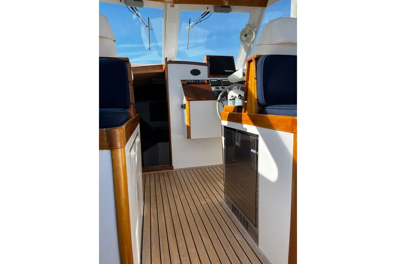 Slide: The Image of Interior of 2003 Lyman-Morse Monhegan 30 boat with wooden flooring and modern controls. - 6