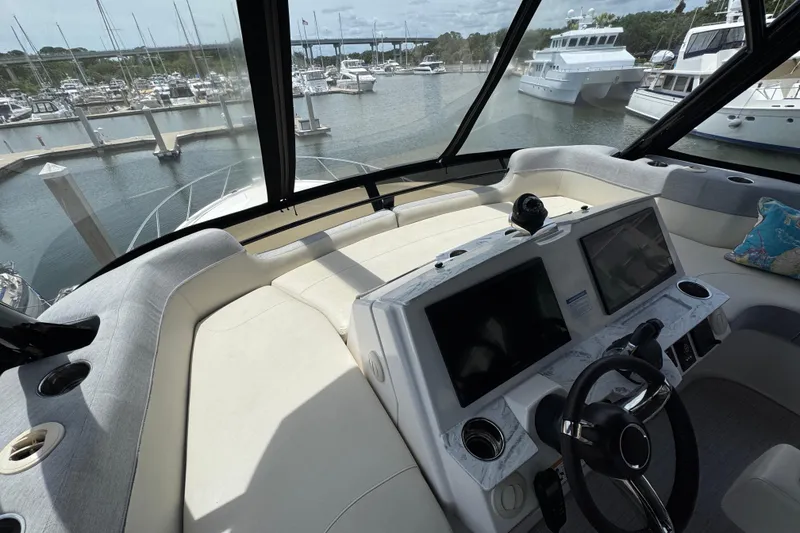 Slide: The Image of Luxurious 2017 Tiara Yachts F53 Flybridge helm with marina view. - 11
