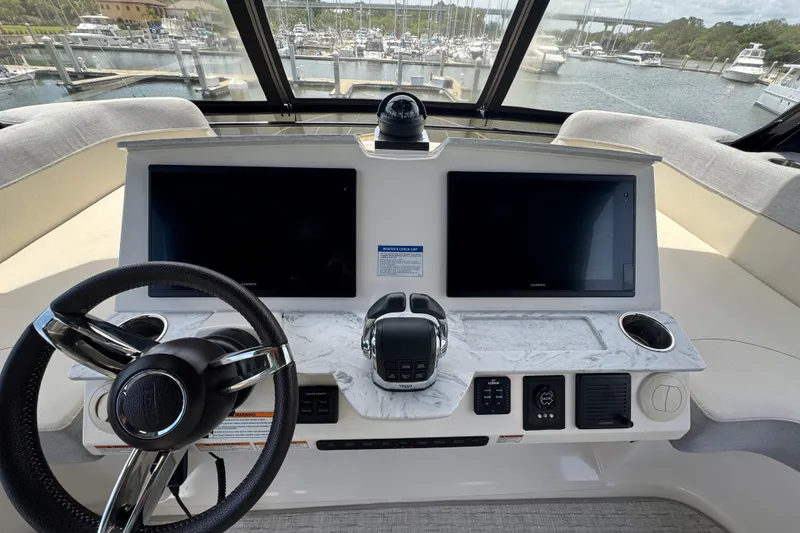 Slide: The Image of Helm of 2017 Tiara Yachts F53 Flybridge with dual screens and steering wheel. - 12