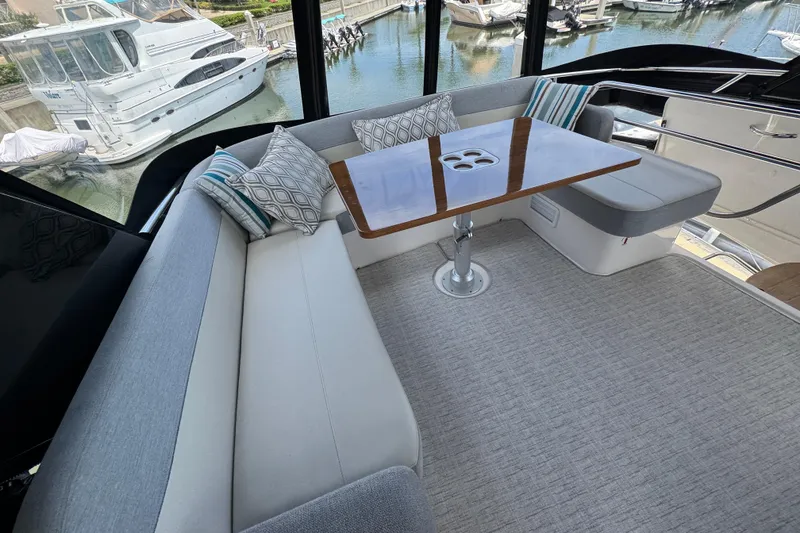 Slide: The Image of Luxurious seating area on 2017 Tiara Yachts F53 Flybridge with elegant cushions and table. - 15