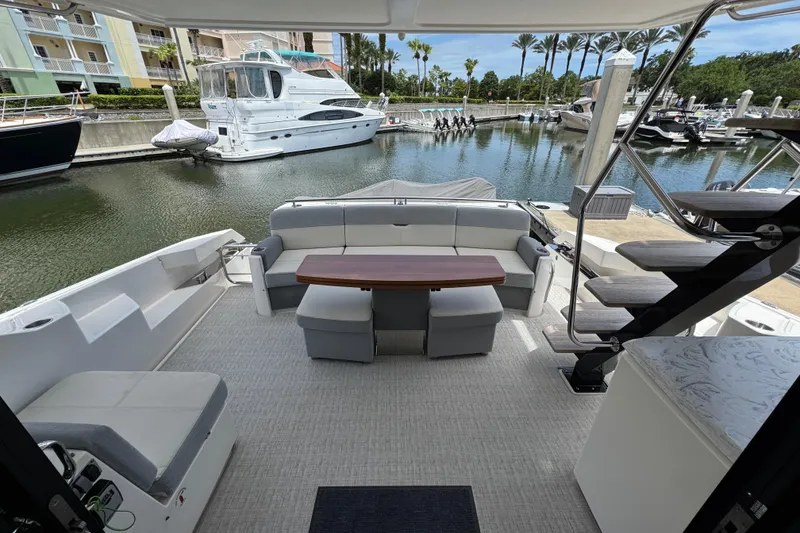 Slide: The Image of Luxurious 2017 Tiara Yachts F53 Flybridge interior with elegant seating and marina view. - 18