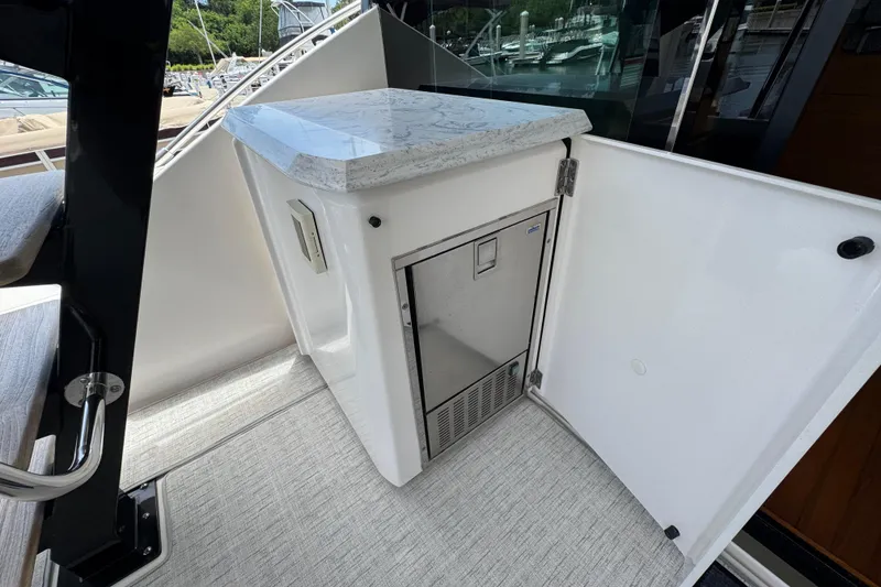 Slide: The Image of 2017 Tiara Yachts F53 Flybridge interior with sleek countertop and built-in storage. - 21