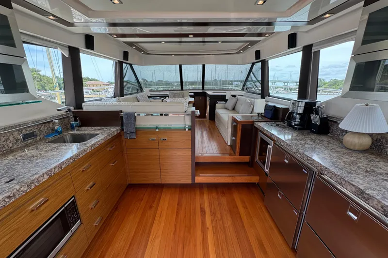 Slide: The Image of Luxurious interior of 2017 Tiara Yachts F53 Flybridge with modern kitchen and seating area. - 25