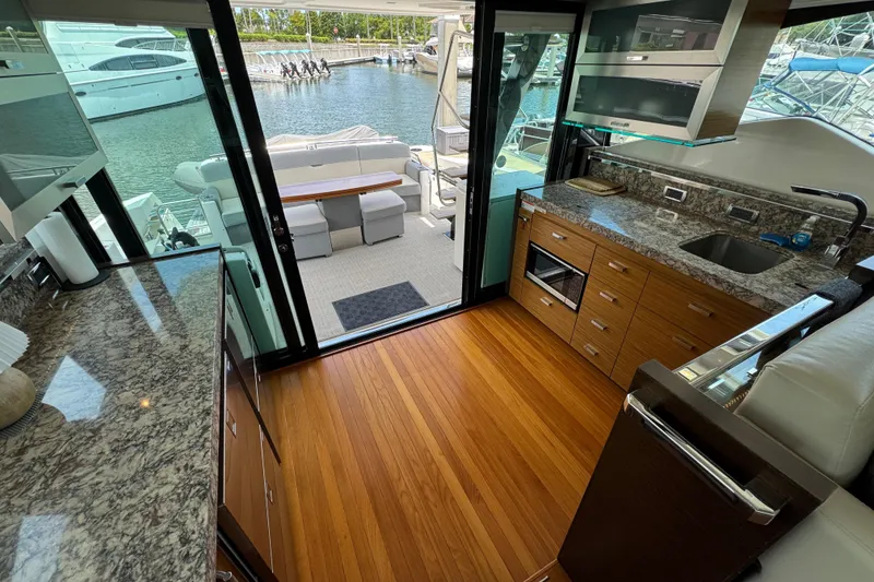 Slide: The Image of Luxurious interior of 2017 Tiara Yachts F53 Flybridge with modern kitchen and marina view. - 26