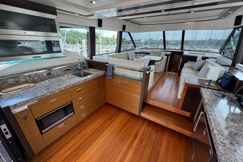 Slide: The Image of Luxurious interior of 2017 Tiara Yachts F53 Flybridge with modern kitchen and seating area. - 27