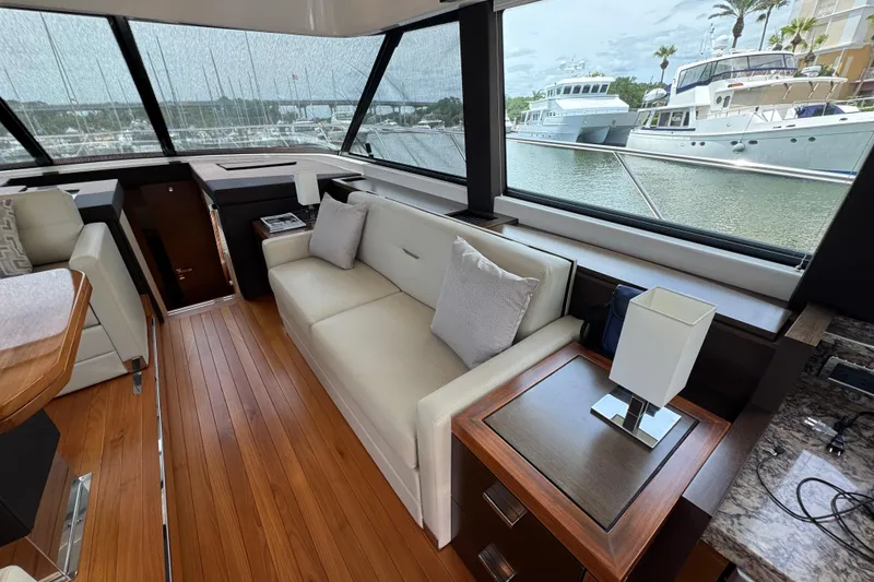Slide: The Image of Luxurious interior of 2017 Tiara Yachts F53 Flybridge with elegant seating and scenic marina view. - 34