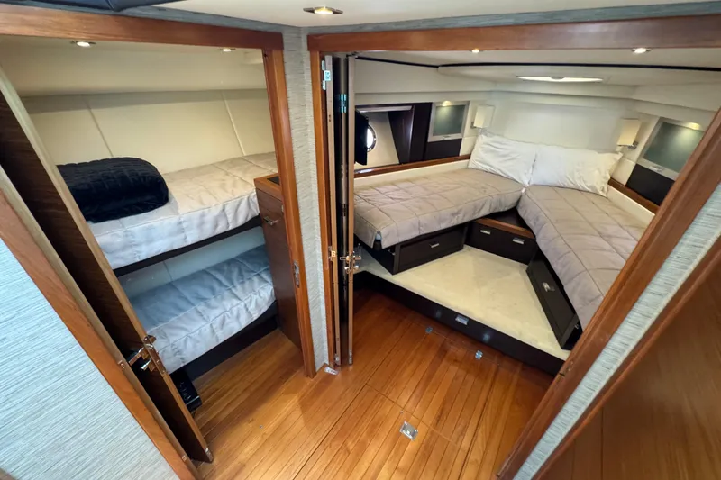Slide: The Image of Luxurious 2017 Tiara Yachts F53 Flybridge cabin with twin beds and elegant wood finish. - 38
