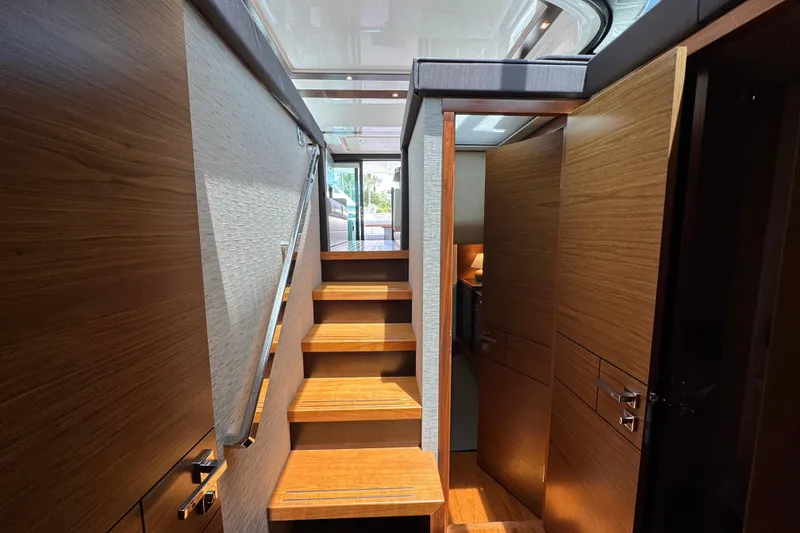 Slide: The Image of Interior staircase of 2017 Tiara Yachts F53 Flybridge, featuring wooden finishes and modern design. - 39