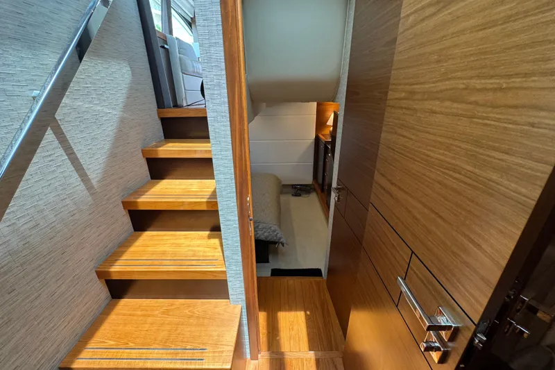Slide: The Image of Interior view of 2017 Tiara Yachts F53 Flybridge, featuring wooden stairs and modern design. - 40
