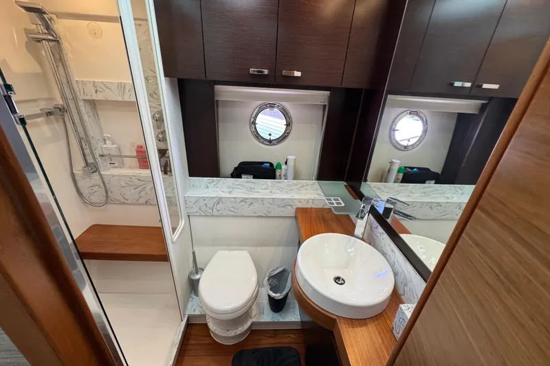 Slide: The Image of Luxurious bathroom in 2017 Tiara Yachts F53 Flybridge with modern fixtures and wood accents. - 42