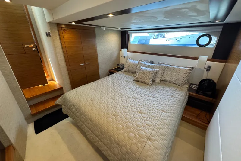 Slide: The Image of Luxurious bedroom interior of 2017 Tiara Yachts F53 Flybridge, featuring elegant bedding and wood accents. - 47