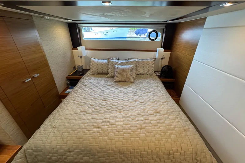 Slide: The Image of Luxurious bedroom interior of 2017 Tiara Yachts F53 Flybridge with elegant bedding and wood accents. - 49
