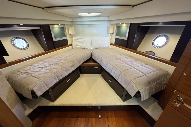 Slide: The Image of Luxurious 2017 Tiara Yachts F53 Flybridge cabin with twin beds and elegant decor. - 53