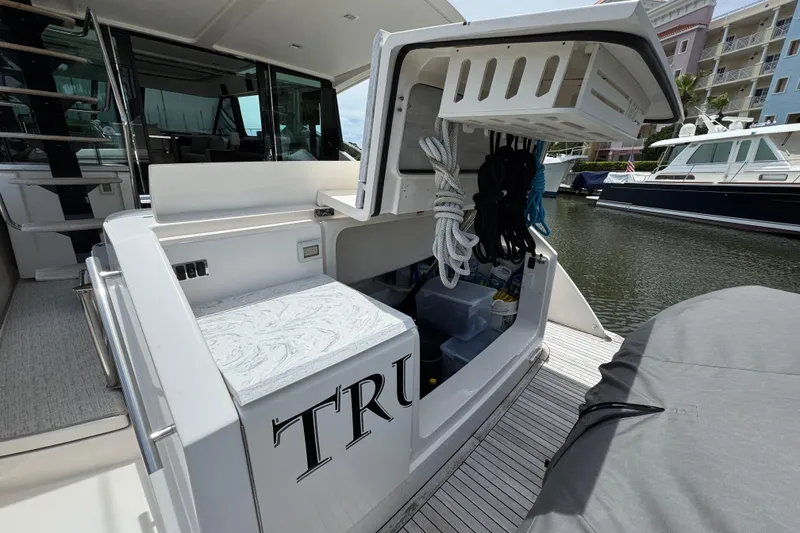 Slide: The Image of 2017 Tiara Yachts F53 Flybridge with open storage compartment at marina. - 55