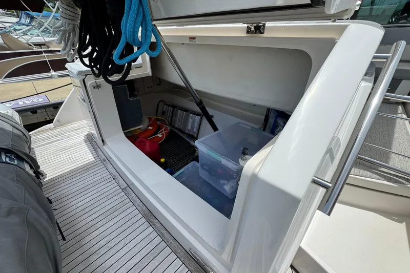 Slide: The Image of Storage compartment on a 2017 Tiara Yachts F53 Flybridge, featuring ropes and equipment. - 56