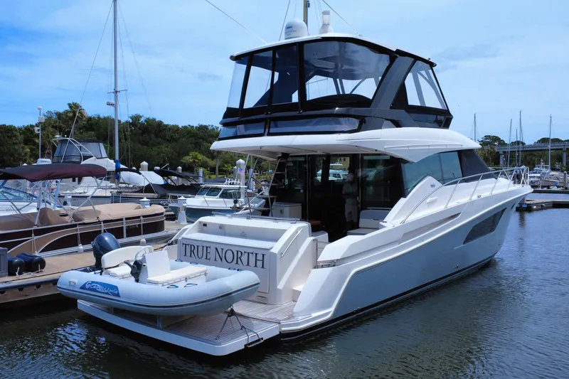 Slide: The Image of 2017 Tiara Yachts F53 Flybridge docked with inflatable boat, named "True North." - 6