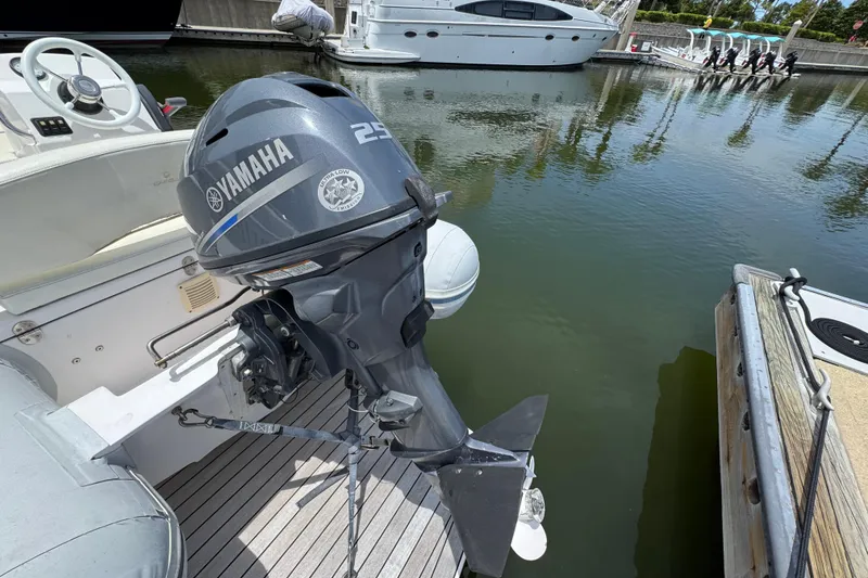 Slide: The Image of Outboard Yamaha motor on a 2017 Tiara Yachts F53 Flybridge, docked in a marina. - 60