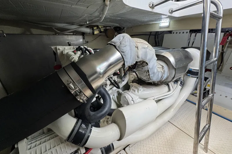 Slide: The Image of Engine room of 2017 Tiara Yachts F53 Flybridge, showcasing detailed mechanical components. - 64