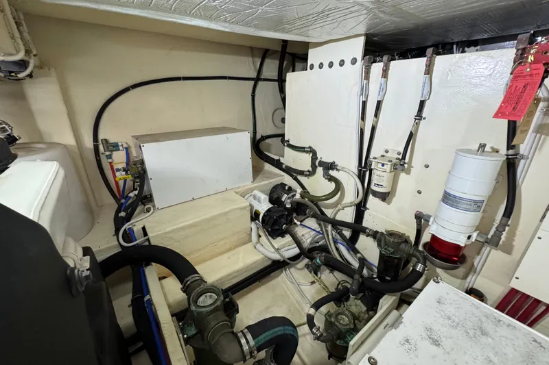 Slide: The Image of Engine room of 2017 Tiara Yachts F53 Flybridge, showcasing mechanical components and piping. - 67