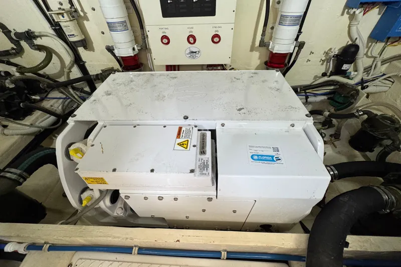 Slide: The Image of Engine room of 2017 Tiara Yachts F53 Flybridge with generator and control panel. - 68
