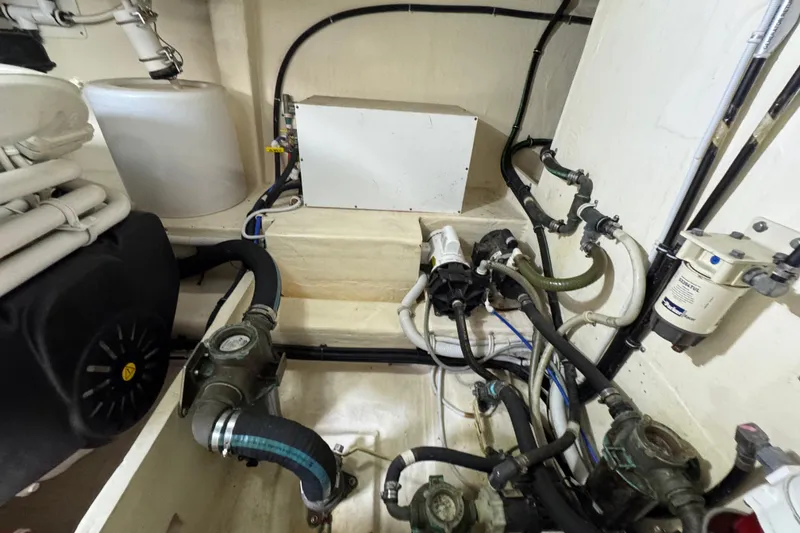 Slide: The Image of Engine room of 2017 Tiara Yachts F53 Flybridge with visible hoses and components. - 69