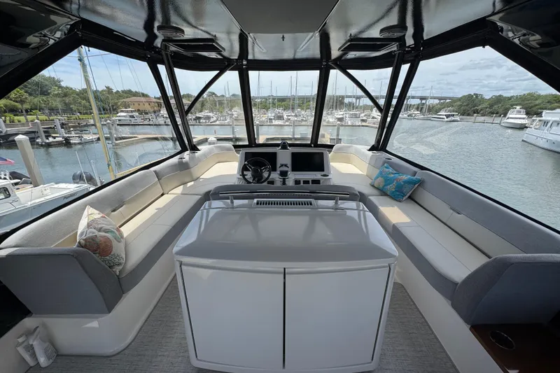 Slide: The Image of Luxurious 2017 Tiara Yachts F53 Flybridge interior with panoramic marina view. - 7