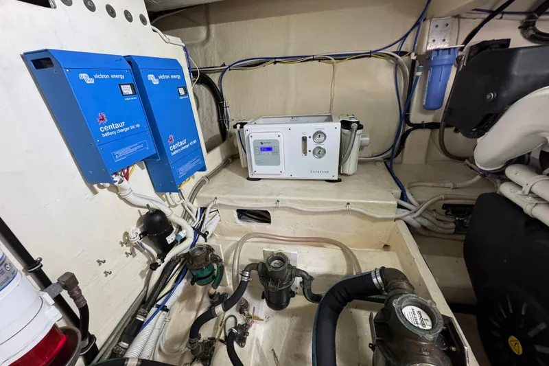 Slide: The Image of Engine room of 2017 Tiara Yachts F53 Flybridge with battery chargers and equipment. - 70