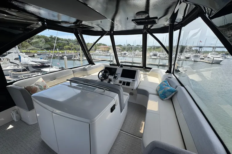 Slide: The Image of Luxurious 2017 Tiara Yachts F53 Flybridge interior with panoramic marina view. - 8