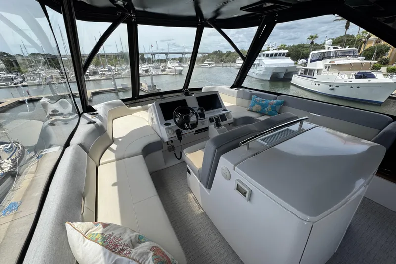 Slide: The Image of Luxurious 2017 Tiara Yachts F53 Flybridge interior with marina view. - 9