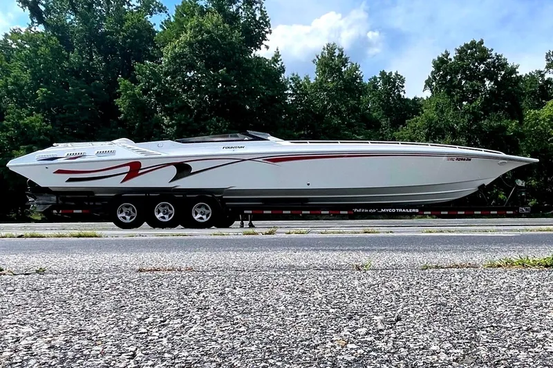 The Image of 1995 Fountain 42 Lightning boat on trailer, parked on roadside with trees in background. - 0