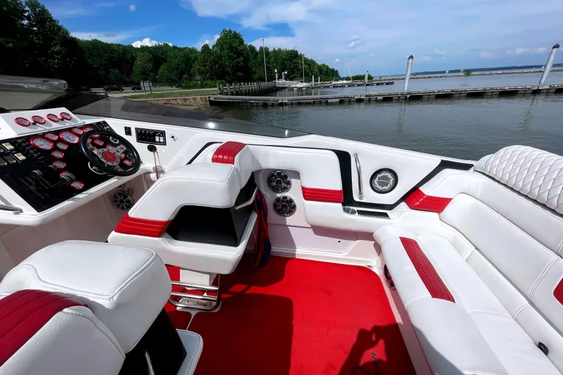 Slide: The Image of Interior of 1995 Fountain 42 Lightning boat with red and white seating, dockside view. - 13