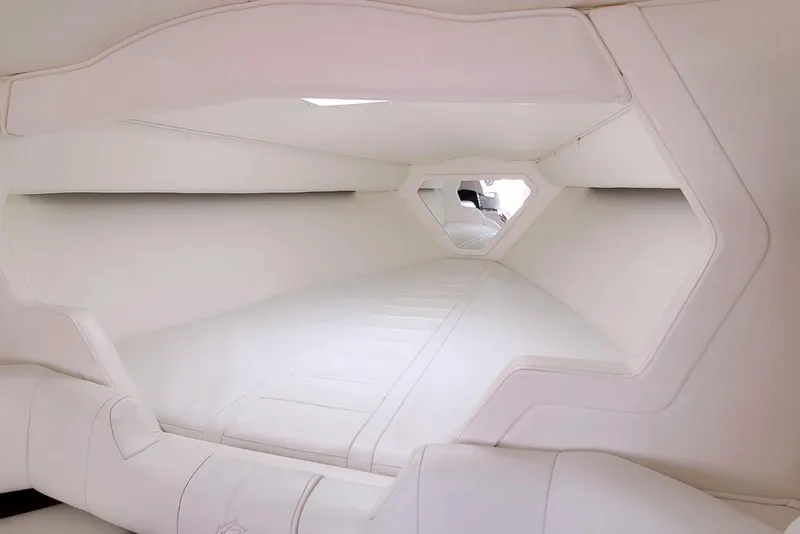Slide: The Image of Interior cabin of a 1995 Fountain 42 Lightning boat, featuring sleek white upholstery. - 17