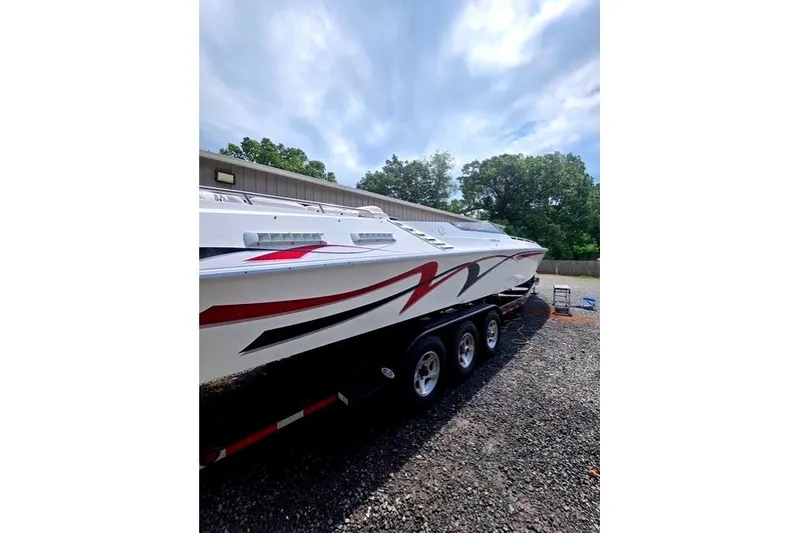Slide: The Image of 1995 Fountain 42 Lightning boat on trailer, featuring sleek red and black graphics. - 2
