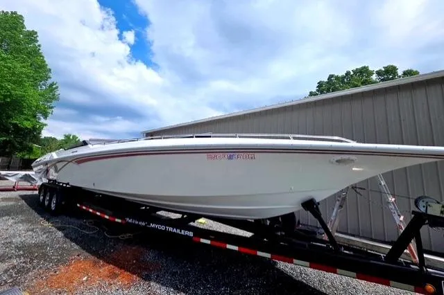 Slide: The Image of 1995 Fountain 42 Lightning speedboat on trailer, parked outdoors near a building. - 3