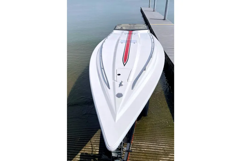 Slide: The Image of 1995 Fountain 42 Lightning speedboat docked, showcasing sleek design and vibrant red stripe. - 4