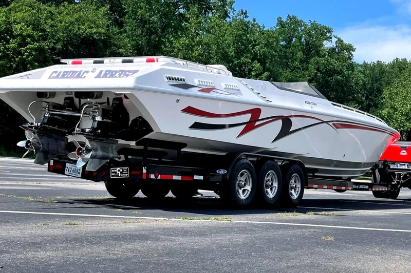 Slide: The Image of 1995 Fountain 42 Lightning speedboat on trailer, featuring sleek design and vibrant graphics. - 9