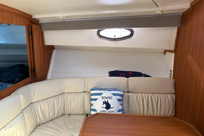 Slide: The Image of Interior of 2008 Stamas 370 Express boat with cozy seating and nautical-themed pillow. - 11